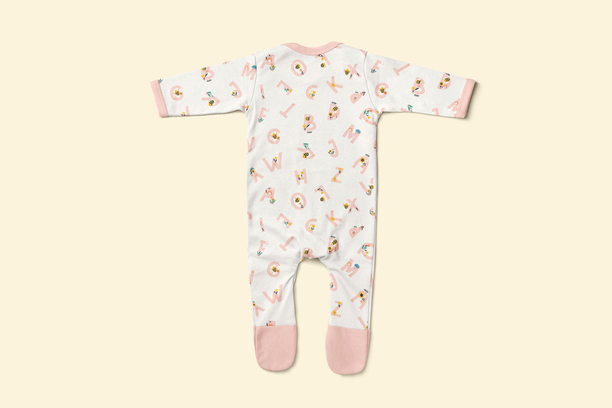 Back of baby rompersuit with pink alphabet pattern and pink accents